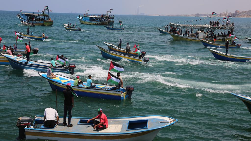 A picture taken on May 29, 2018 shows fishing boats carrying a group of Palestinian activists who are protesting and perhaps trying to breach Israel's naval blockade on Gaza, setting to sail from Gaza City harbour. The Gaza Strip has been under Israe