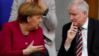FILE PHOTO: German Chancellor Angela Merkel talks to Interior Minister Horst Seehofer during a session of the Bundestag in Berlin, Germany, March 21, 2018. REUTERS/Fabrizio Bensch/File Photo