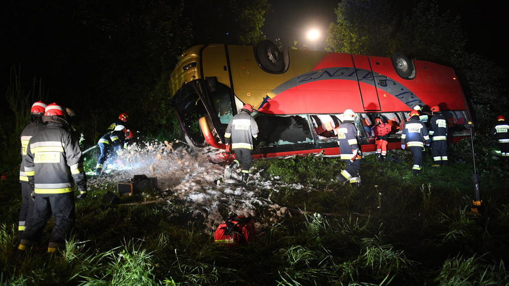 18.08.2018, Polen, Leszczawa: Feuerwehrleute sind am Unglücksort im Einsatz. In der Nacht vom 17. auf den 18.08.2018 verunglückte ein ukrainischer Bus zwischen den Städten Przemysl und Sanok. Drei Menschen kamen bei dem Unfall ums Leben. Foto: Darek