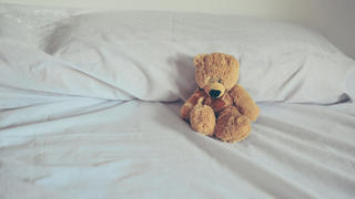 Teddy Bear in white bed