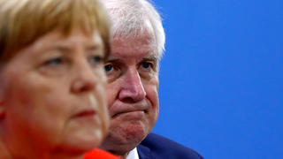 FILE PHOTO: German Chancellor Angela Merkel and Interior Minister Horst Seehofer address a news conference following the so called a housing summit on rising rents in many German cities and a general shortage of affordable housing in Berlin, Germany September 21, 2018. REUTERS/Fabrizio Bensch/File Photo