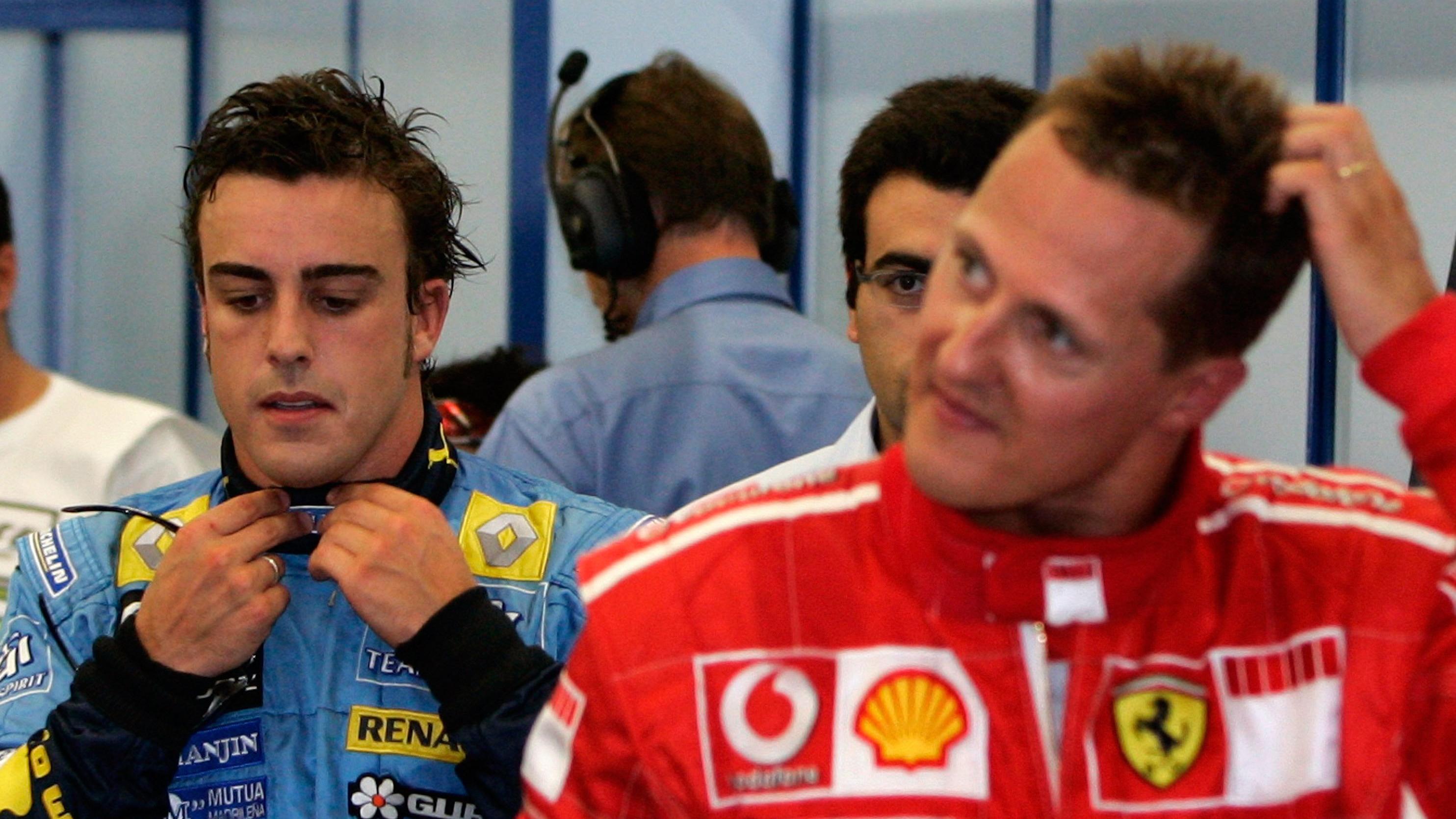German Formula One driver Michael Schumacher (R) of Scuderia Ferrari and Spanish Fernando Alonso (rear) of Renault F1 team seen after the Qualifying session at the Istanbul Park circuit near Istanbul, Turkey on Saturday; 26 August 2006. Felipe Masa o