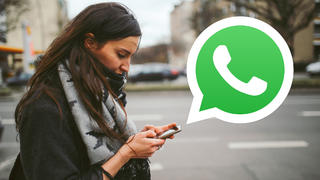 Frau mit Smartphone, großes Whatsapp-Logo
