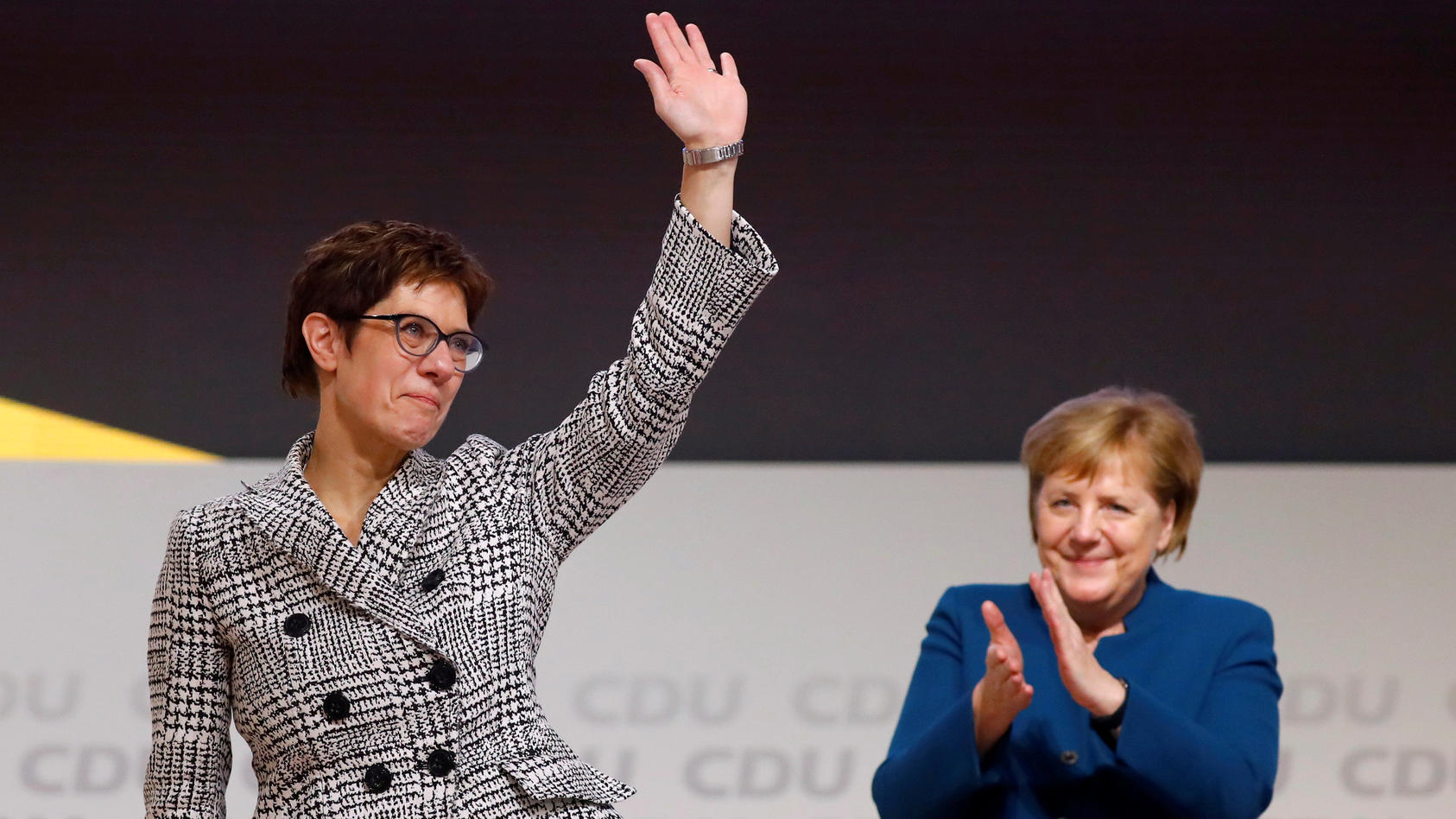 Annegret Kramp-Karrenbauer waves next to German Chancellor Angela Merkel after being elected as the party leader during the Christian Democratic Union (CDU) party congress in Hamburg, Germany, December 7, 2018. REUTERS/Kai Pfaffenbach     TPX IMAGES 