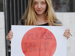 Amanda Seyfried holds up a 'Please Help' sign in support of the victims of the Japanese Earthquake and Tsunami while out with a friend in West Hollywood, CA.
