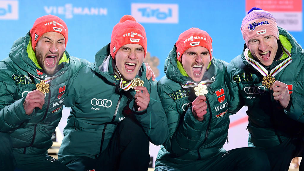 24.02.2019, Österreich, Seefeld: Ski nordisch, Weltmeisterschaft, Skispringen, Teamspringen, Herren. Markus Eisenbichler (l-r), Stephan Leyhe, Richard Freitag und Karl Geiger aus Deutschland jubeln nach der Siegerehrung mit ihren Goldmedaillen. Foto: