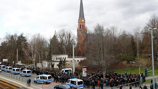 Police escort supporters of Thomas Haller, founder of Neo-Nazi ultra-right group "HooNaRa" who died ten days ago, as they gather for his funeral in Chemnitz, Germany, March 18, 2019. REUTERS/Fabrizio Bensch