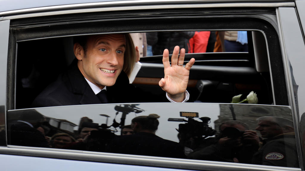 French President Emmanuel Macron waves to the crowd as he leaves by car after casting his ballot as part of the vote for the European parliamentary election in Le Touquet, France May 26, 2019. Ludovic Marin/Pool via REUTERS