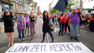 Women pose behind a banner reading "Pay. Time. Respect." during a women's strike (Frauenstreik) in Zurich, Switzerland June 14, 2019. REUTERS/Arnd Wiegmann