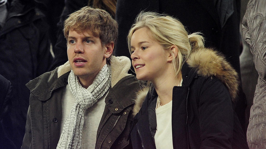 German Formula 1 and Grand Prix driver Sebastian Vettel (L) and his girlfriend Hanna Prater look at the playing field during the Spanish league football match between FC Barcelona and Valencia CF on February 19, 2012, at the Camp Nou stadium in Barce