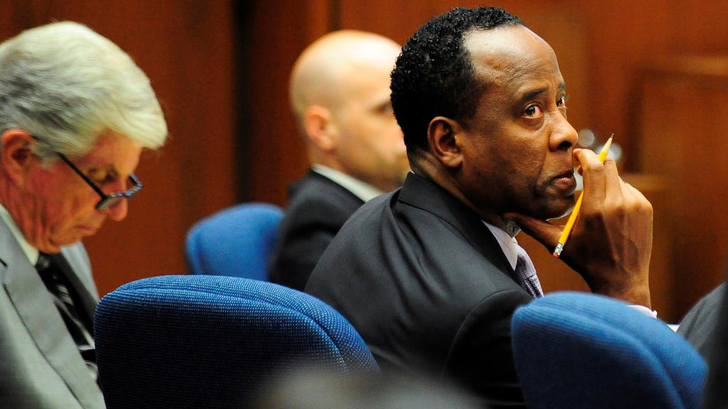 FILE PHOTO: Dr. Conrad Murray watches the proceedings during his trial in the death of pop star Michael Jackson, in Los Angeles October 12, 2011. At left is his attorney J. Michael Flanagan. REUTERS/Robyn Beck/Pool/File Photo PLEASE SEARCH "FROM THE 