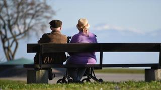 Zwei Pensionäre sitzen auf einer Bank