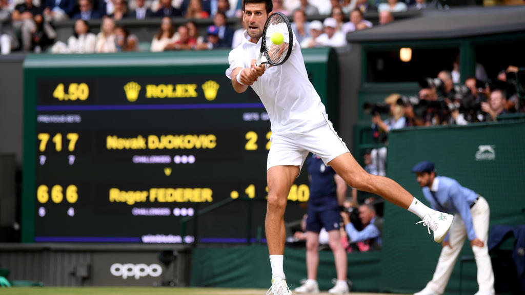 LONDON, ENGLAND - JULY 14: Novak Djokovic of Serbia plays a backhand in his Men's Singles final against Roger Federer of Switzerland during Day thirteen of The Championships - Wimbledon 2019 at All England Lawn Tennis and Croquet Club on July 14, 201