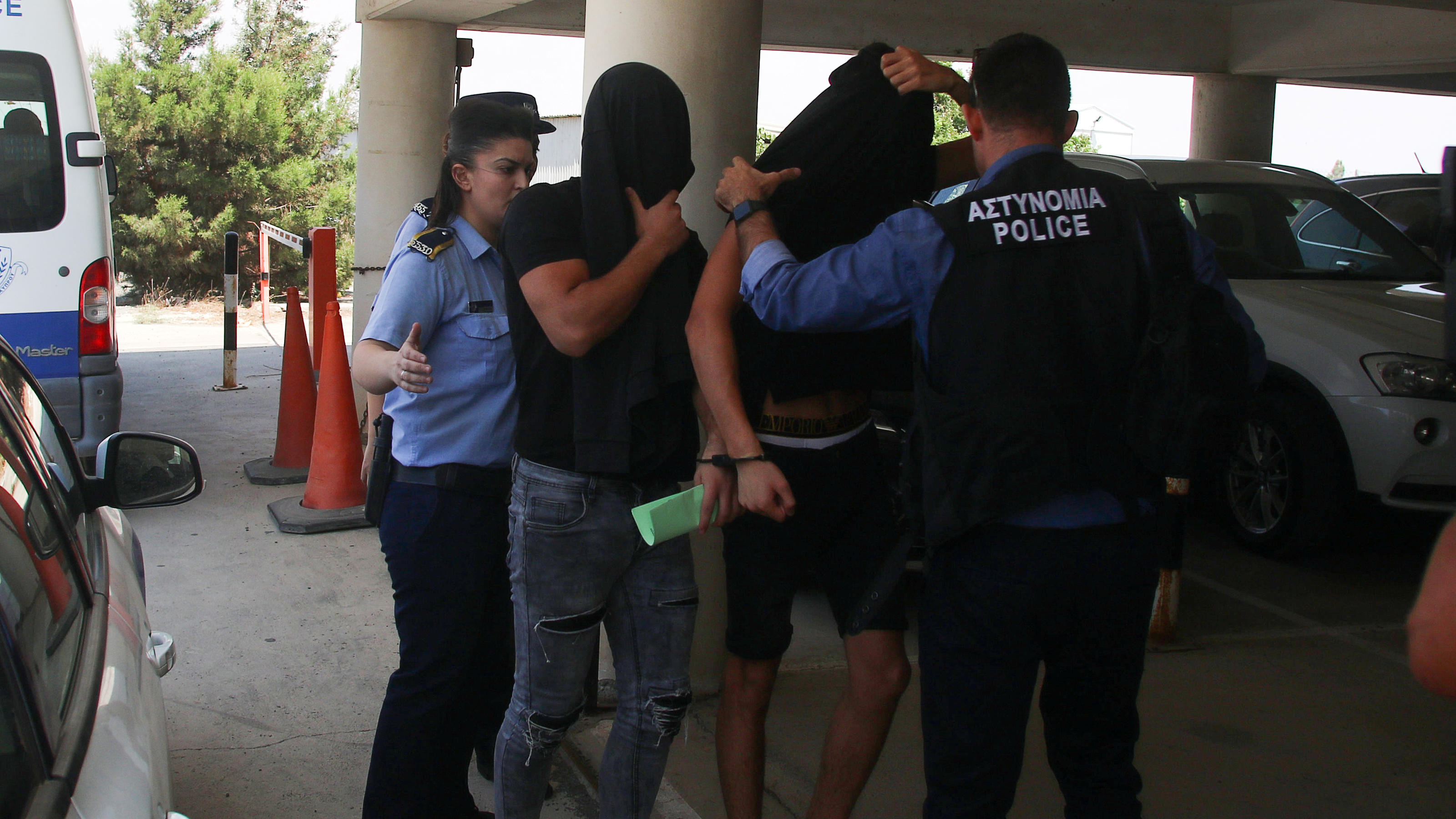 Israeli tourists, arrested over the alleged rape of a British tourist in the resort town of Ayia Napa, arrive to appear before a magistrate for a remand hearing in the Famagusta courthouse in Paralimni, Cyprus July 18, 2019. REUTERS/Yiannis Kourtoglo
