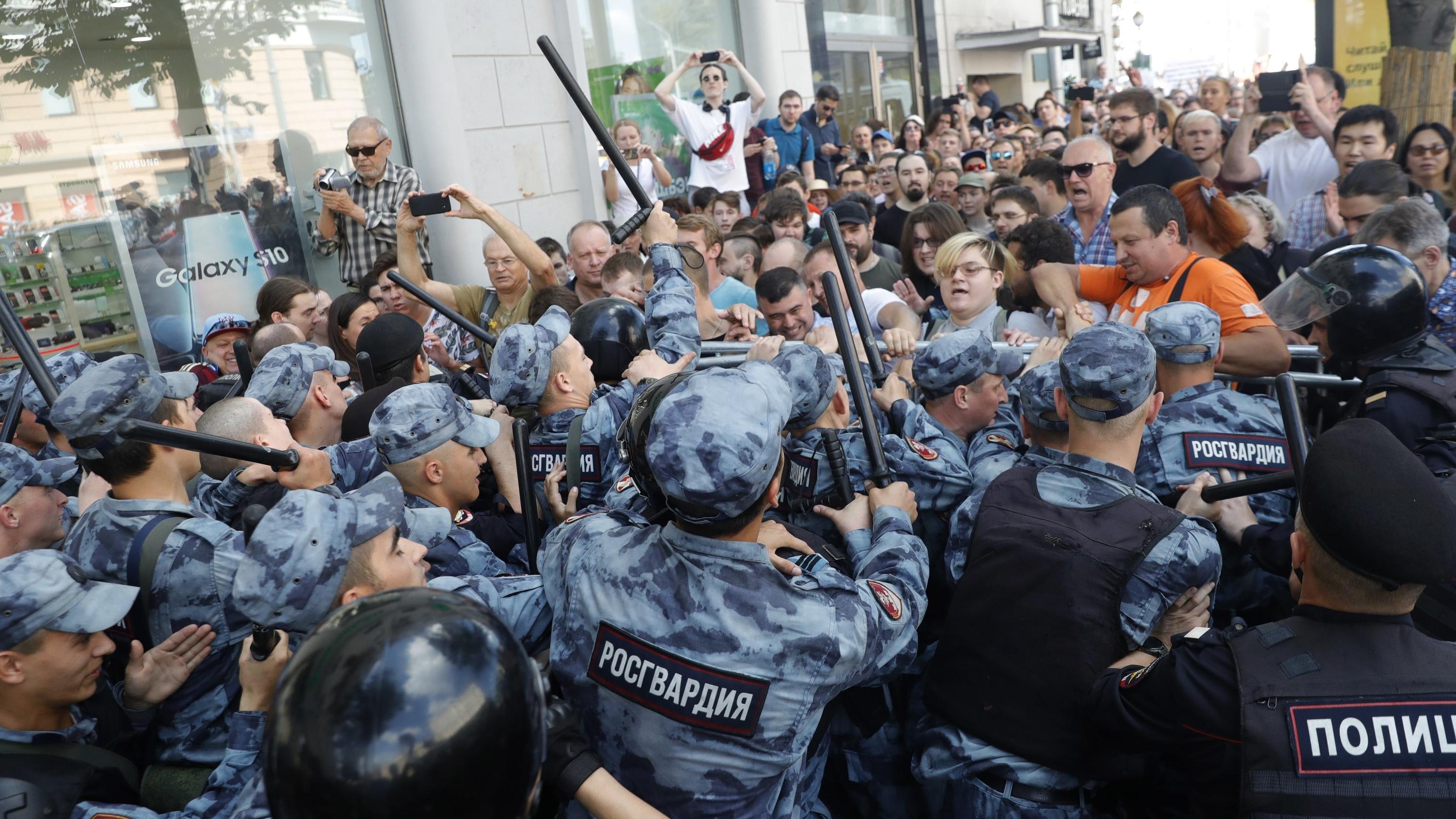 27.07.2019, Russland, Moskau: Demonstranten geraten mit der Polizei während einer nicht genehmigten Kundgebung im Zentrum von der Stadt aneinander. Begleitet von einem massiven Aufgebot der Polizei haben am Samstag in Moskau Hunderte Menschen gegen d