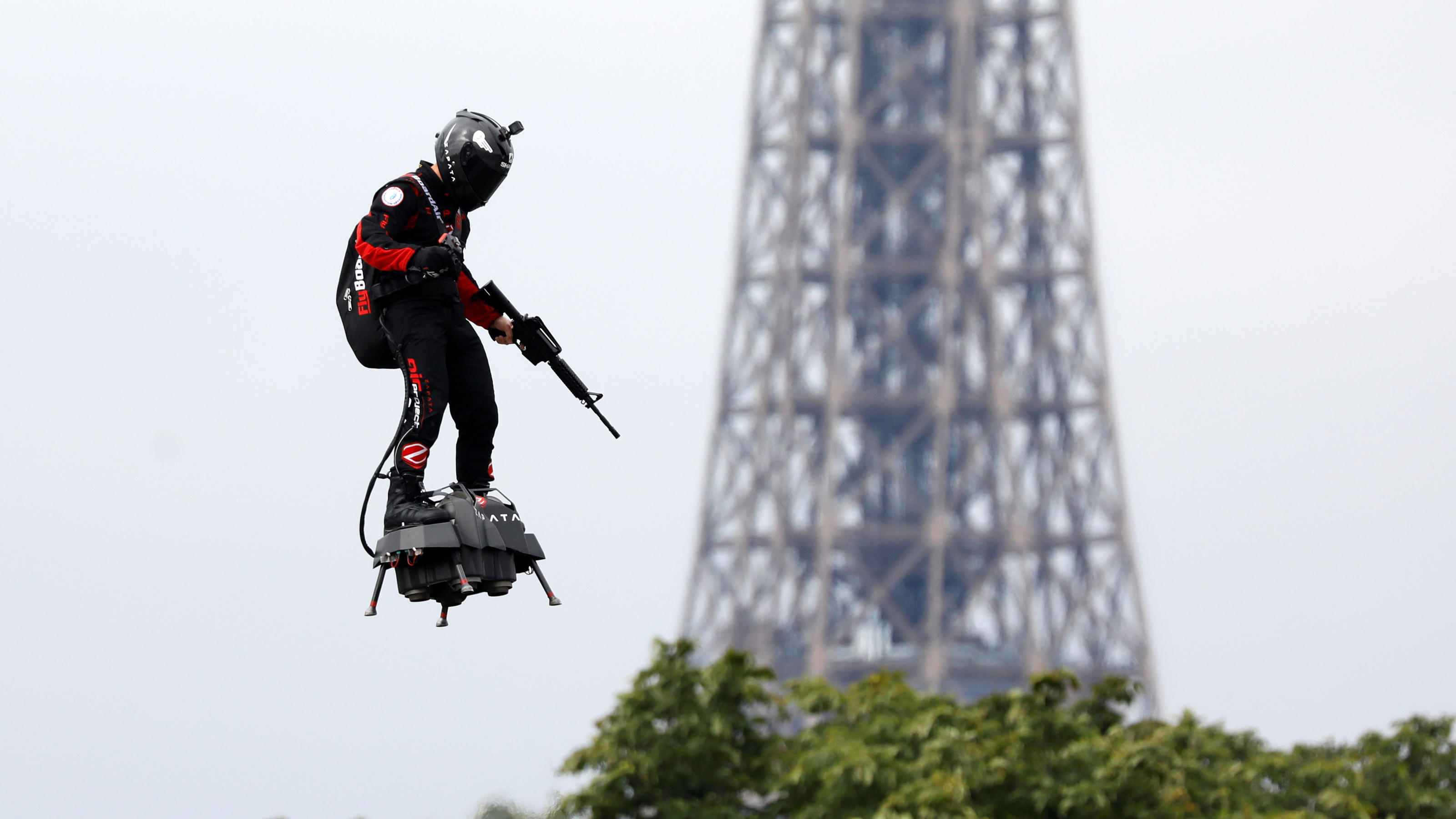 Franky Zapata flies on a Flyboard near the Eiffel Tower during the traditional Bastille Day military parade on the Champs-Elysees Avenue in Paris, France, July 14, 2019. REUTERS/Charles Platiau