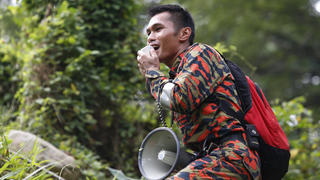 09.08.2019, Malaysia, Seremban: Ein Mitglied eines Rettungsteams benutzt einen Lautsprecher bei einer Such- und Rettungsaktion für ein vermisstes britisches Mädchen in einem Wald in Seremban, Negeri Sembilan. Die Polizei in Malaysia sagte am Donnerstag, dass sie mit Hilfe von Sprachaufzeichnungen von der Familie nach dem 15-jährigen vermissten Mädchen aus London sucht. Foto: Lai Seng Sin/AP/dpa +++ dpa-Bildfunk +++
