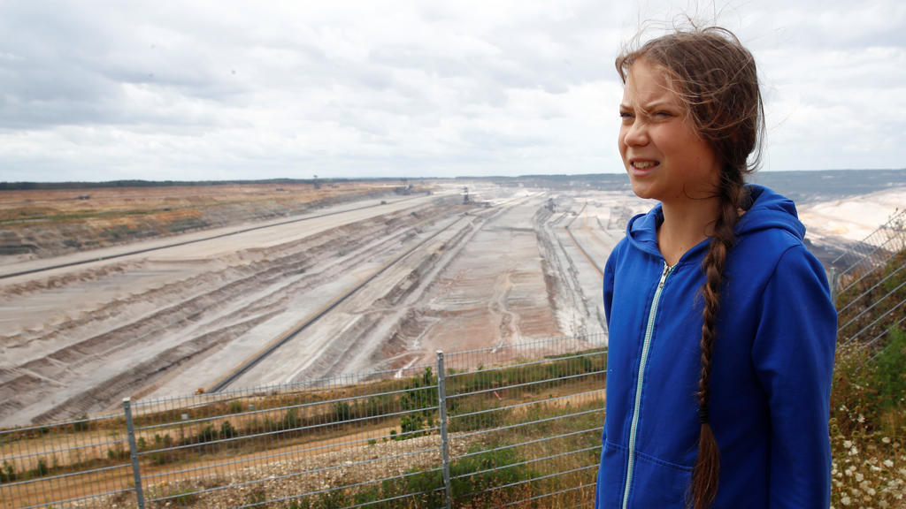 Greta Thunberg, Swedish "Fridays for Future" climate activist, stands at the edge of the Hambach open-cast brown coal mine of German utility RWE, west of Cologne, Germany, August 10, 2019. REUTERS/Wolfgang Rattay
