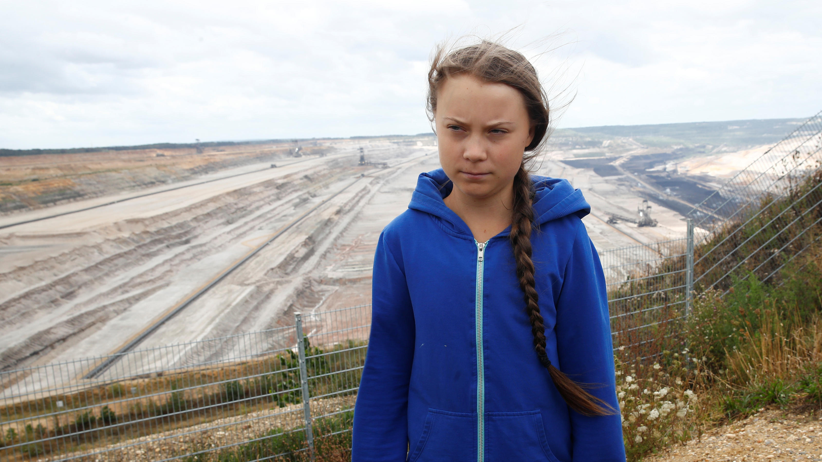 Greta Thunberg, Swedish "Fridays for Future" climate activist, stands at the edge of the Hambach open-cast brown coal mine of German utility RWE, west of Cologne, Germany, August 10, 2019.   REUTERS/Wolfgang Rattay