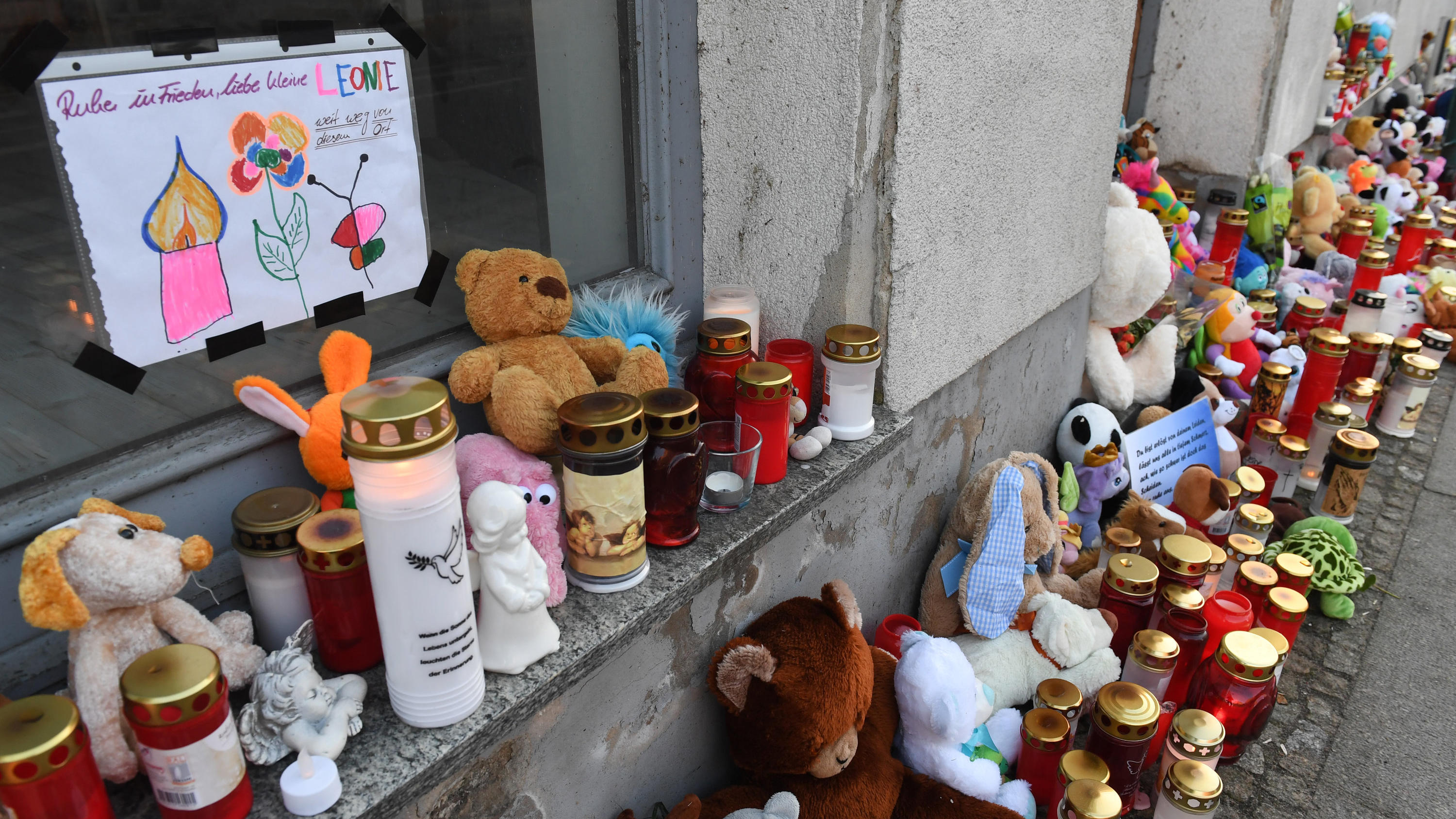 Kerzen und Plüschtiere stehen vor dem Eingang des Hauses, wo am 12.01.2019 eine Sechsjährige ums Leben kam. Knapp neun Monate nach dem Tod der sechsjährigen Leonie aus Torgelow  beginnt am 24.09.