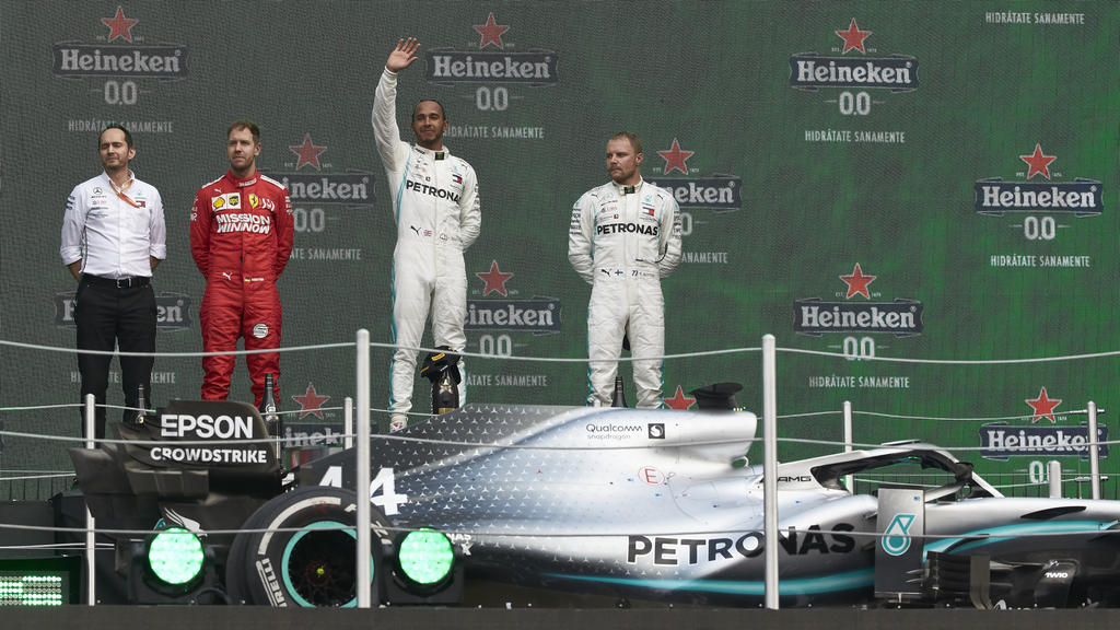 2019 Mexican GP MEXICO CITY - OCTOBER 27: Sebastian Vettel, Ferrari, 2nd position, Valtteri Bottas, Mercedes AMG F1, 3rd position, and Lewis Hamilton, Mercedes AMG F1, 1st position, on the podium during the 2019 Formula One Mexican Grand Prix at Aut