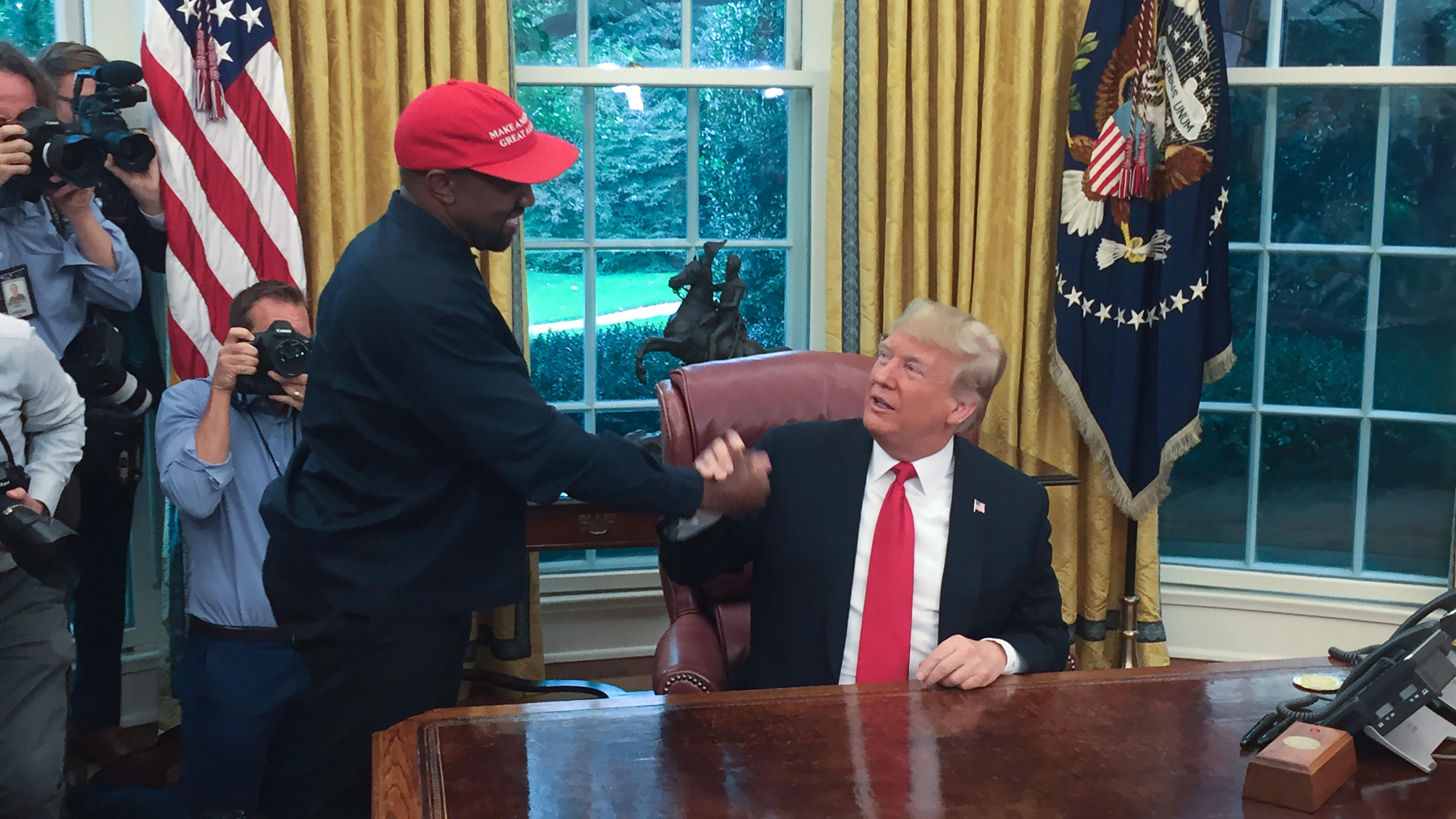 (Files) in this file photo US President Donald Trump meets with rapper Kanye West in the Oval Office of the White House in Washington, DC, October 11, 2018. - Rapper Kanye West, who has been outspoken in his support for President Donald Trump, now sa