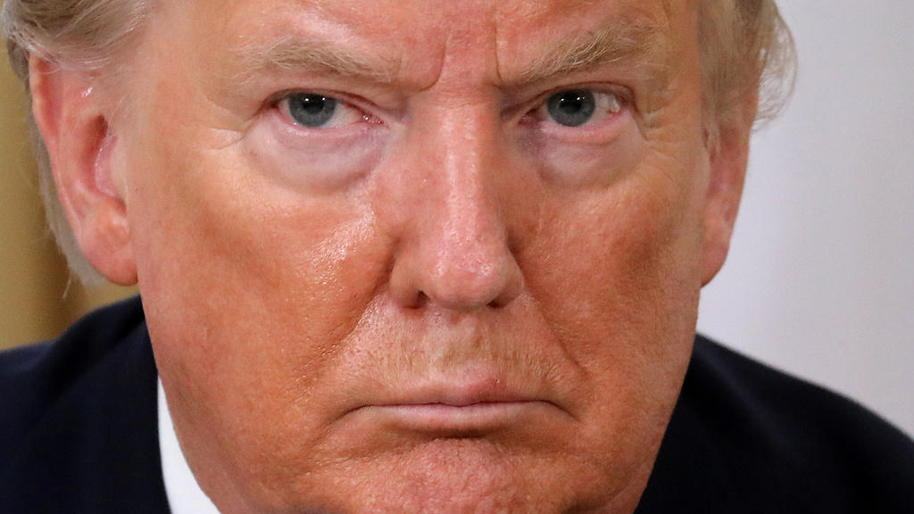 U.S. President Donald Trump reacts during the meeting with France's President Emmanuel Macron, ahead of the NATO summit in Watford, in London, Britain, December 3, 2019. Ludovic Marin/Pool via REUTERS