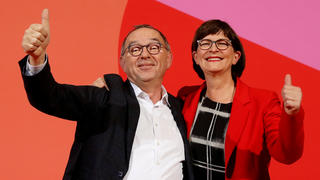 FILE PHOTO: Saskia Esken and Norbert Walter-Borjans gesture after being announced as winners of a Social Democratic Party members' ballot for the party leadership in Berlin, Germany, November 30, 2019. REUTERS/Fabrizio Bensch/File Photo