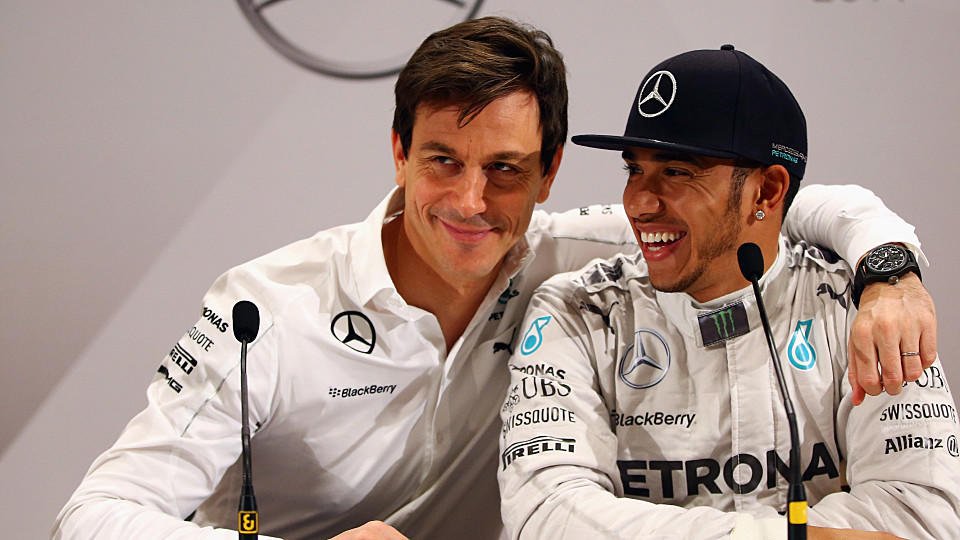 STUTTGART, GERMANY - NOVEMBER 29:  Toto Wolff, the Mercedes GP Executive Director, hugs Lewis Hamilton of Great Britain during a press conference at the annual Mercedes Benz Stars & Cars event in front of the Mercedes Benz Museum on November 29, 2014