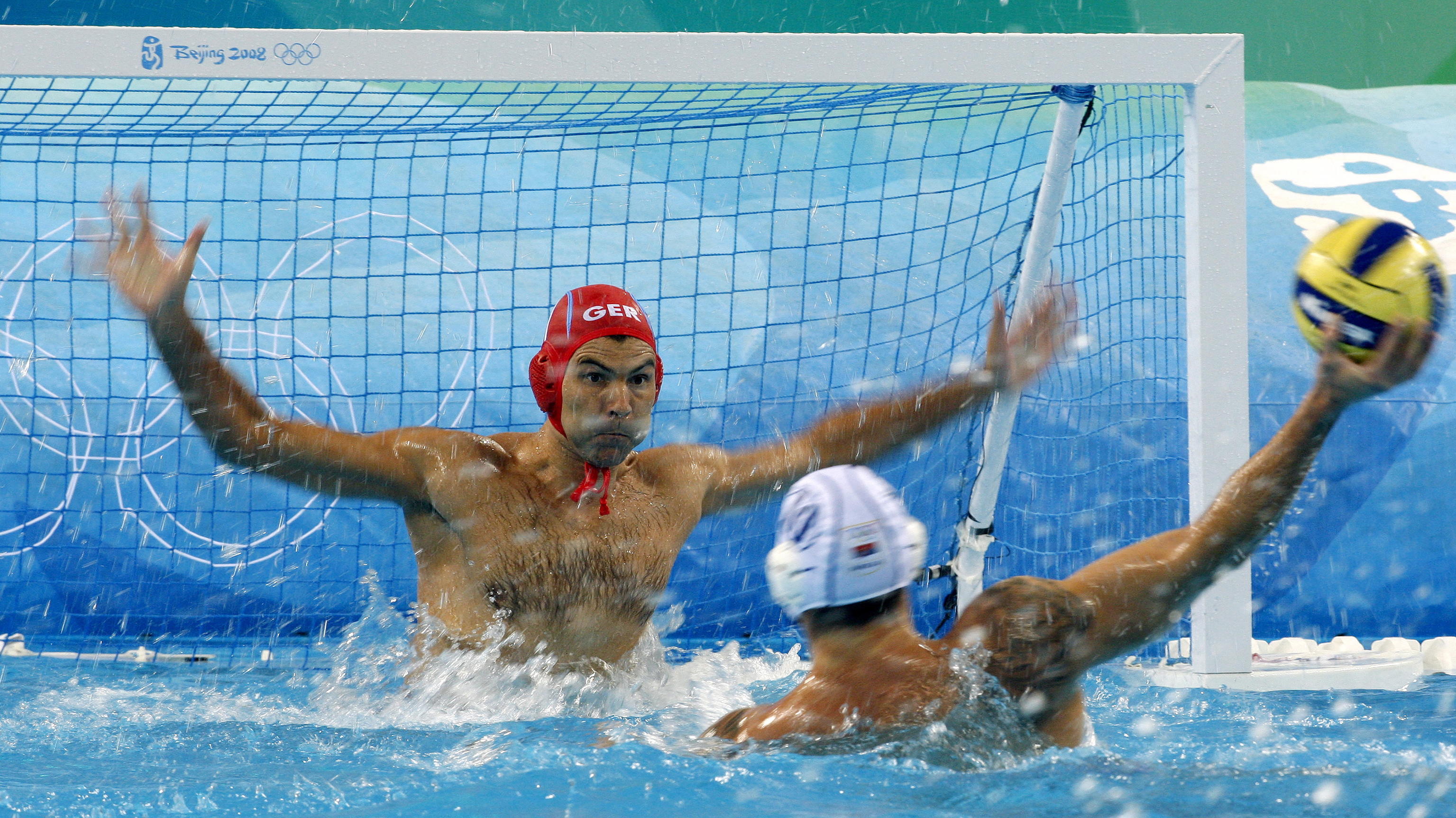 Goalkeeper Alexander Tchigir (L) of Germany vies with Aleksandar Sapic (R) of Serbia during the men's water polo preliminary round group B match 3 between Serbia and Germany competition in the Yingdong Natatorium at the Beijing 2008 Olympic Games, Be