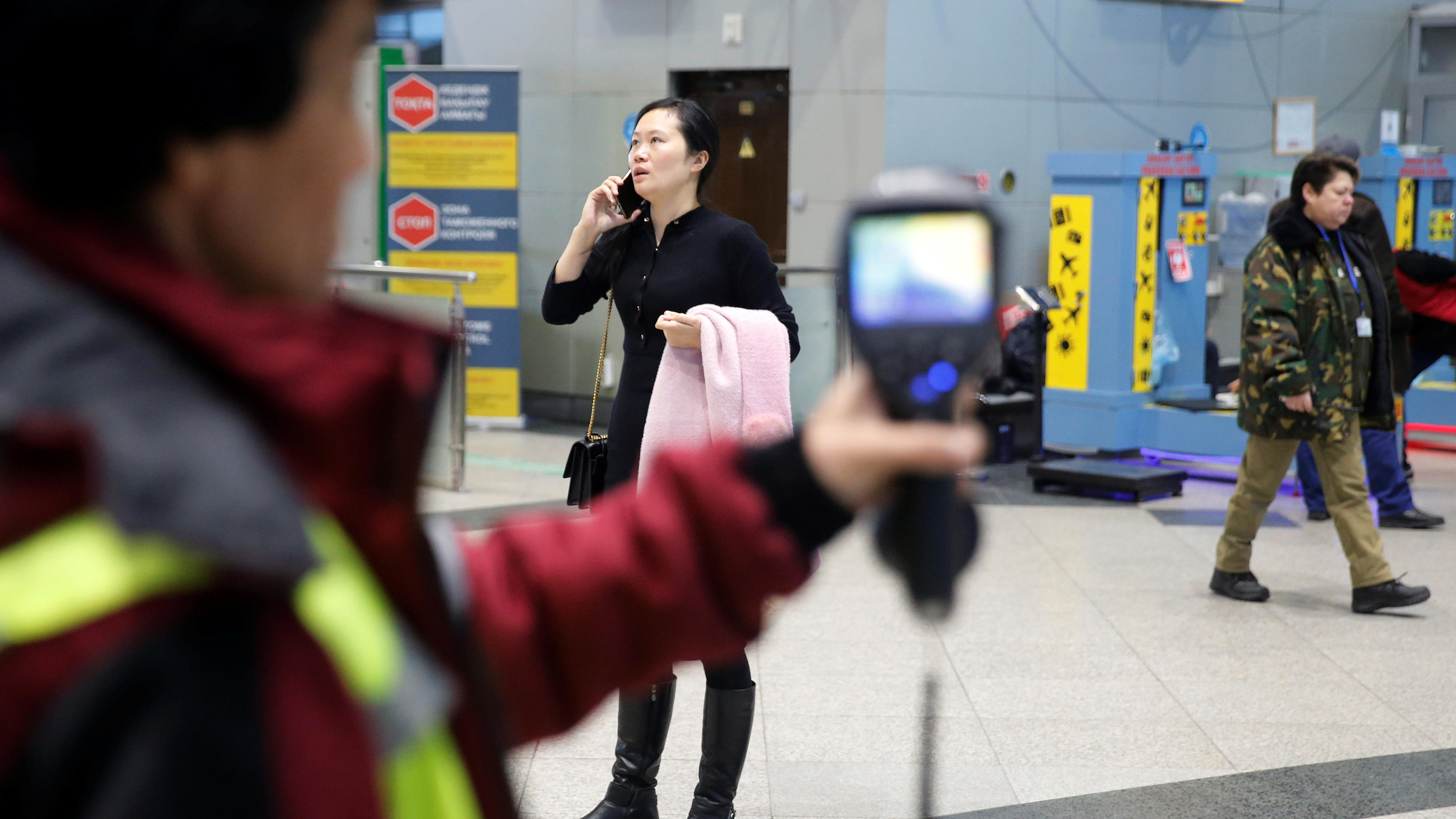 Kazakh sanitary-epidemiological service worker uses a thermal scanner to detect travellers from China who may have symptoms possibly connected with the previously unknown coronavirus, at Almaty International Airport, Kazakhstan January 21, 2020. REUT