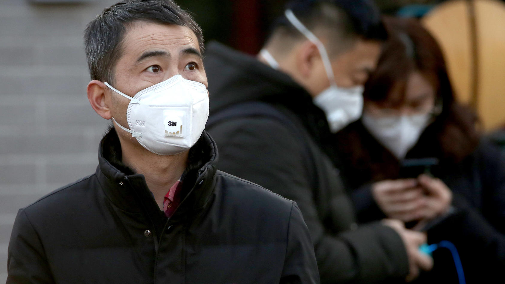  Chinese wear protective respiratory masks in Beijing on Thursday, January 23, 2020. China has locked down some 20 million people a the epicenter of a deadly virus outbreak, Wuhan, banning trains and planes from leaving in an unprecedented move aimed