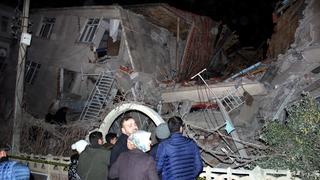People stand outside a collapsed building after an earthquake in Elazig, Turkey, January 24, 2020. Ihlas News Agency (IHA) via REUTERS ATTENTION EDITORS - THIS PICTURE WAS PROVIDED BY A THIRD PARTY. NO RESALES. NO ARCHIVE. TURKEY OUT. NO COMMERCIAL OR EDITORIAL SALES IN TURKEY.