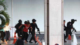 Thai security forces evacuate people stranded inside the Terminal 21 shopping mall following a gun battle, to try to stop a soldier on a rampage after a mass shooting, Nakhon Ratchasima, Thailand February 9, 2020. REUTERS/Athit Perawongmetha