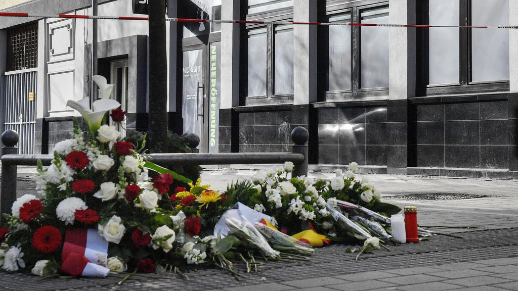 Flowers are seen in front of the hookah bar where a shooting took place in Hanau, Germany, Friday, Feb. 21, 2020 two days after a 43-year-old German man shot and killed several people at several locations in a Frankfurt suburb on Wednesday, Feb. 19,