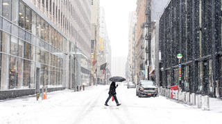 NEW YORK, NY, USA - JANUARY 27 2015 - A pedestrian pass a street in the Financial District, early Tuesday morning on January 27, 2015. In New York City, the blizzard did not amount to what was originally predicted. Photo: Andrew Renneisen/dpa