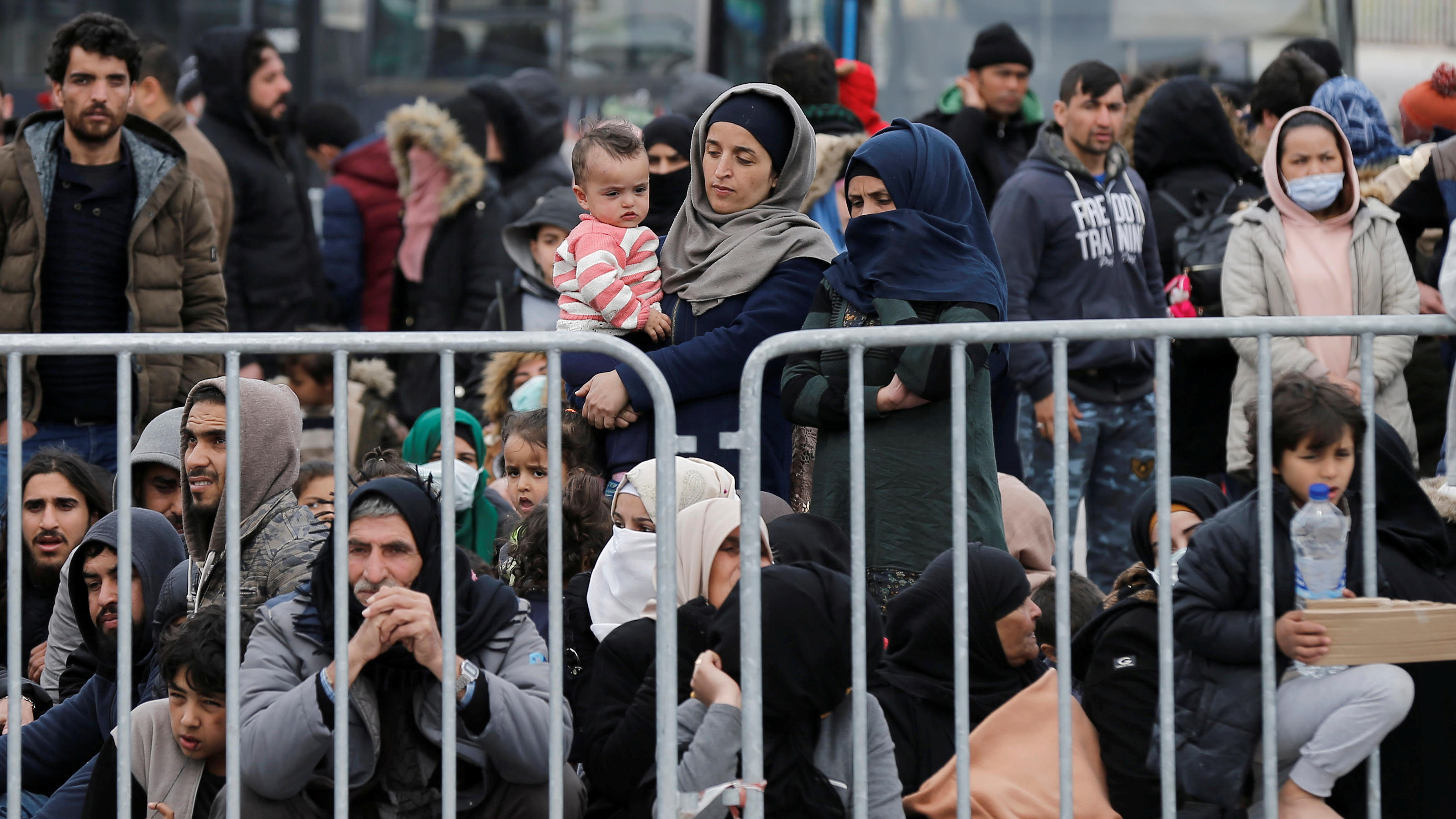 Migrants who arrived on the island of Lesbos in the past four days, are seen at the port of Mytilene, as they wait to board a Greek navy ship, in Mytilene, Greece, March 4, 2020. REUTERS/Costas Baltas