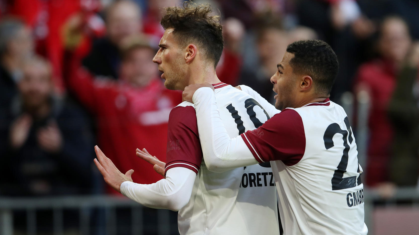 MUNICH, GERMANY - MARCH 08: Leon Goretzka of Bayern Munich celebrates with teammate Serge Gnabry after scoring his team's second goal during the Bundesliga match between FC Bayern Muenchen and FC Augsburg at Allianz Arena on March 08, 2020 in Munich,