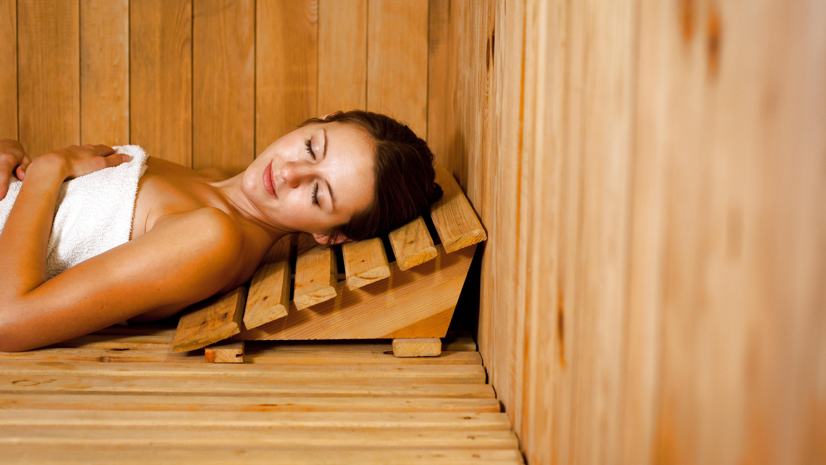 Young woman relaxing in a sauna
