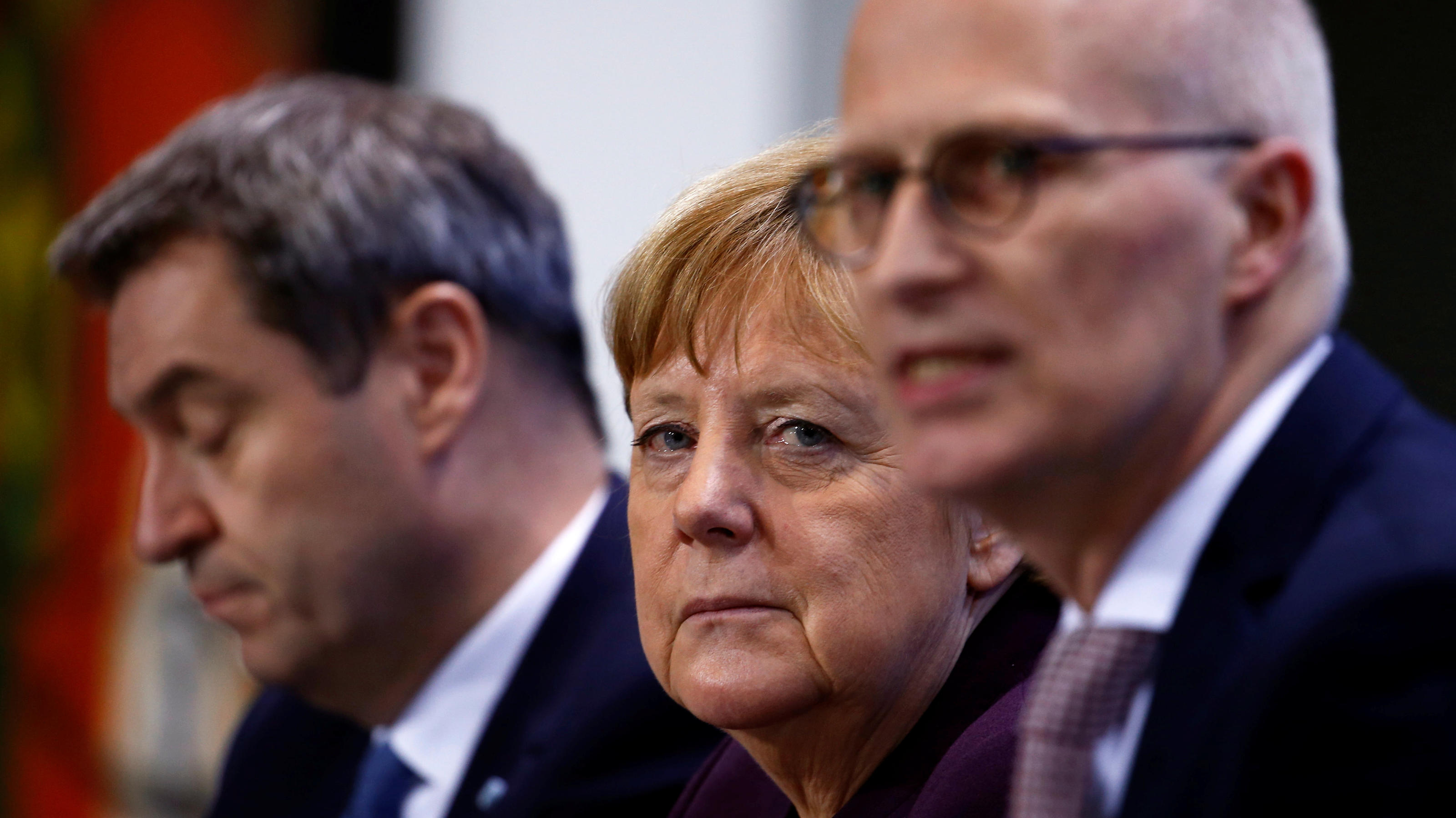 German Chancellor Angela Merkel, Bavarian State Premier Markus Soeder and Hamburg Mayor Peter Tschentsche attend a news conference after a meeting with federal state leaders at the Chancellery in Berlin, Germany March 12, 2020. REUTERS/Michele Tantus