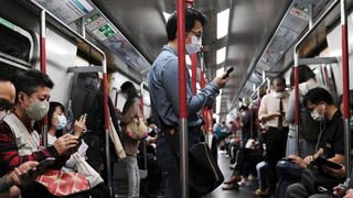 People wear protective masks in an MTR train, following the outbreak of the new coronavirus in Hong Kong, China March 13, 2020. REUTERS/Tyrone Siu