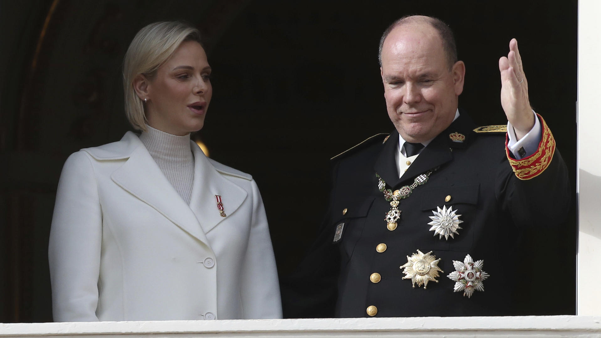 FILE - In this Nov.19, 2019 file photo Prince Albert II of Monaco with his wife Princess Charlene wave from the balcony during the ceremony marking the National Day in Monaco. The palace of Monaco says Prince Albert II has tested positive for the new