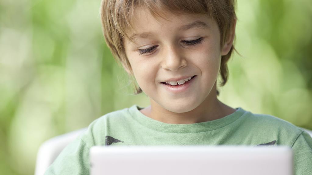 Boy using digital tablet PUBLICATIONxINxGERxSUIxAUTxONLY Copyright: AlexVentura B54258728  