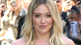 Hilary Duff arrives at AOL building in New York City wearing tight fitting pastel pink dress. 