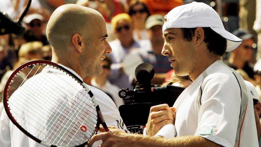 Andre Agassi (L) the United States shakes hands with Benjamin Becker of Germany after losing the final match of his career in their third round match on the seventh day of the 2006 US Open tennis tournament in Flushing Meadows, New York on Sunday 03