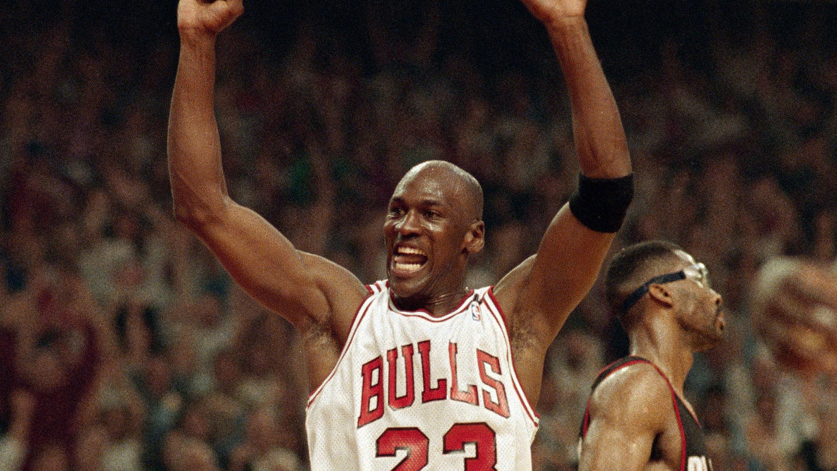 FILE - In this June 14, 1992, file photo, Michael Jordan celebrates the Bulls win over the Portland Trail Blazers in the NBA Finals in Chicago. Decades after Jordan's groundbreaking departure from college, March Madness and the NBA's mega-millions ha