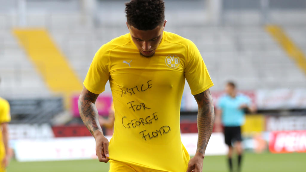 PADERBORN, GERMANY - MAY 31: Jadon Sancho of Borussia Dortmund celebrates scoring his teams second goal of the game with a 'Justice for George Floyd' shirt during the Bundesliga match between SC Paderborn 07 and Borussia Dortmund at Benteler Arena on