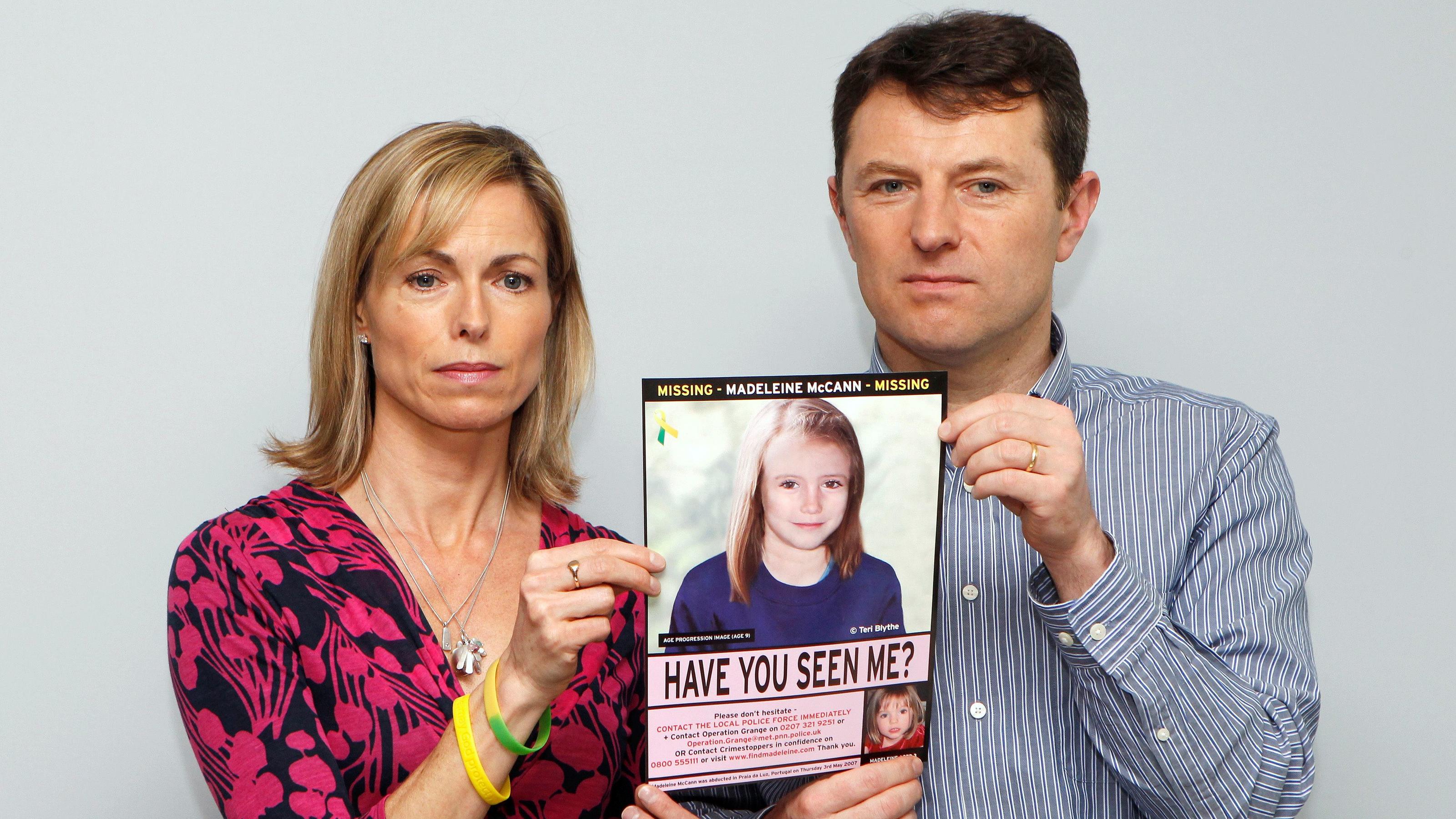 FILE PHOTO: Kate and Gerry McCann pose with a computer generated image of how their missing daughter Madeleine might look now, during a news conference in London May 2, 2012. REUTERS/Andrew Winning/File Photo