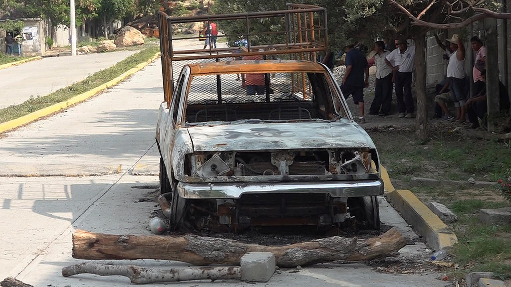 The burnt wreckage of a truck lies on a street after assailants killed 15 inhabitants of an indigenous village, that has been plagued by local disputes, in San Mateo del Mar, in Oaxaca state, Mexico June 22, 2020. REUTERS/Jose de Jesus Cortes