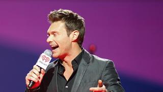 Britney Spears and host Ryan Seacrest introduces a musical group during the 2012 iHeartRadio Music Festival at the MGM Grand Garden Arena in Las Vegas, Nevada September 21, 2012. REUTERS/Steve Marcus (UNITED STATES - Tags: ENTERTAINMENT SOCIETY)